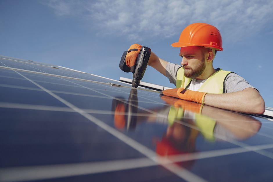 Team installing residential solar panels on a roof